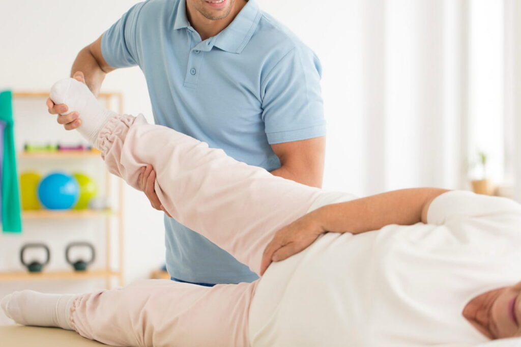 Physical therapist working on a patient's leg