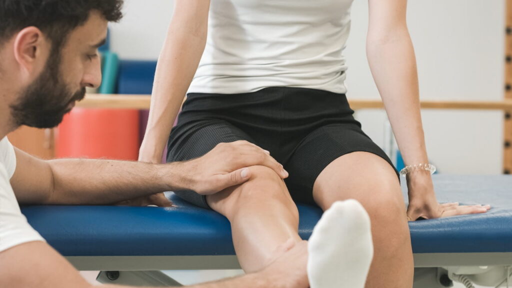 Physical therapist working on a patient's knee
