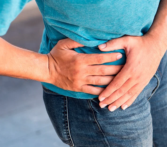 man grabbing hip with his hands