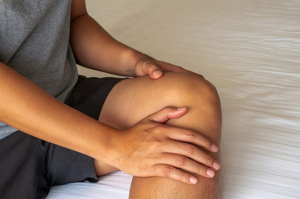person rubbing their knee