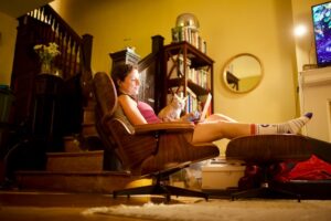 Girl relaxing on a chair with her cat