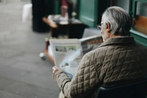 Elderly man reading a newspaper