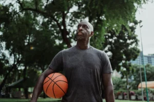 older man warms up before playing basketball