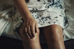 close up of a woman holding her right knee