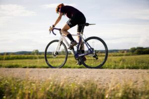 man biking along dirt road