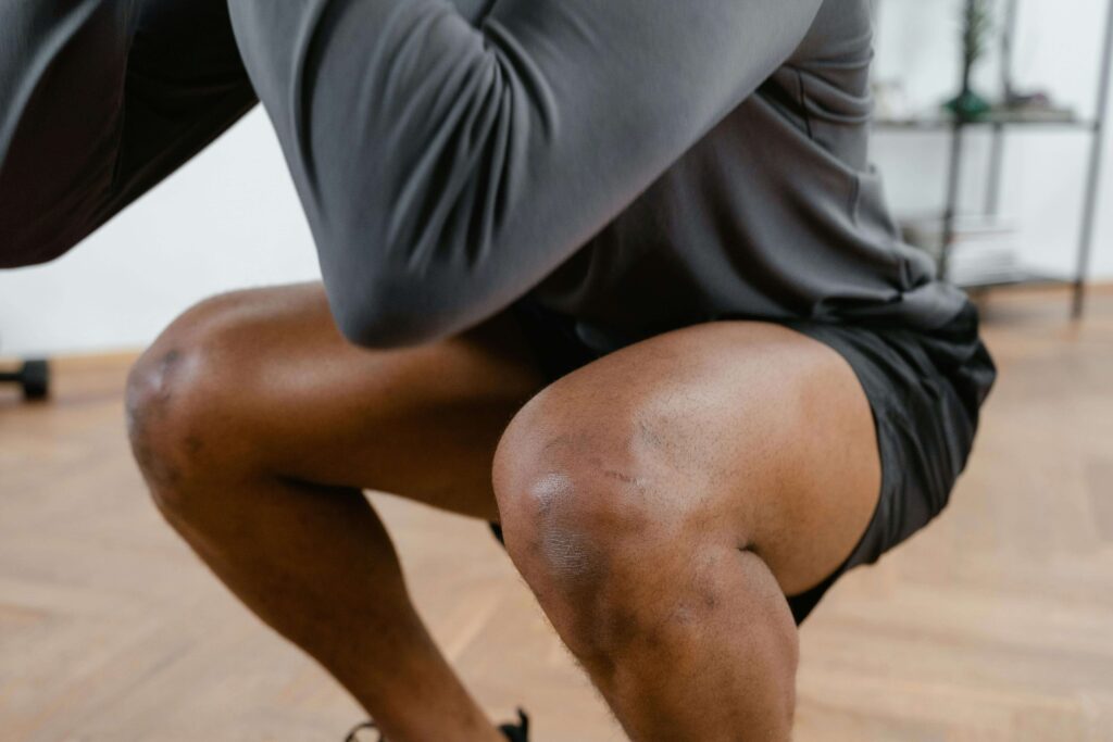 photo of man squatting in the gym