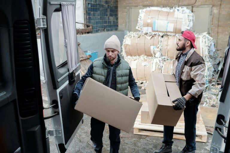 two men lifting boxes