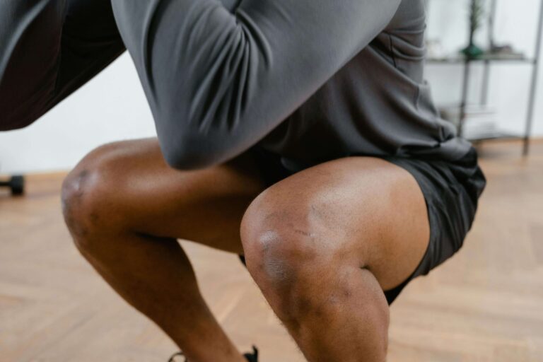 close up of man squatting during exercise routine