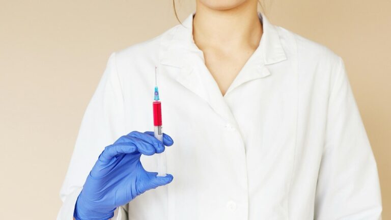 close up of medical professional holding a syringe