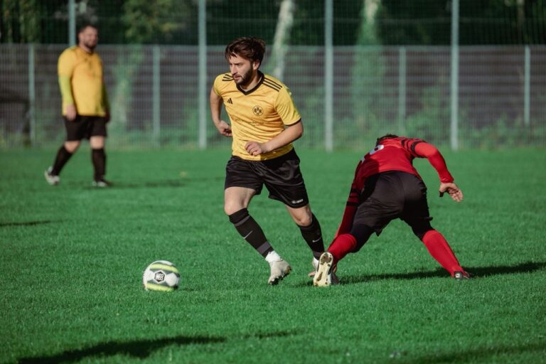 man falling after guarding a play during soccer game