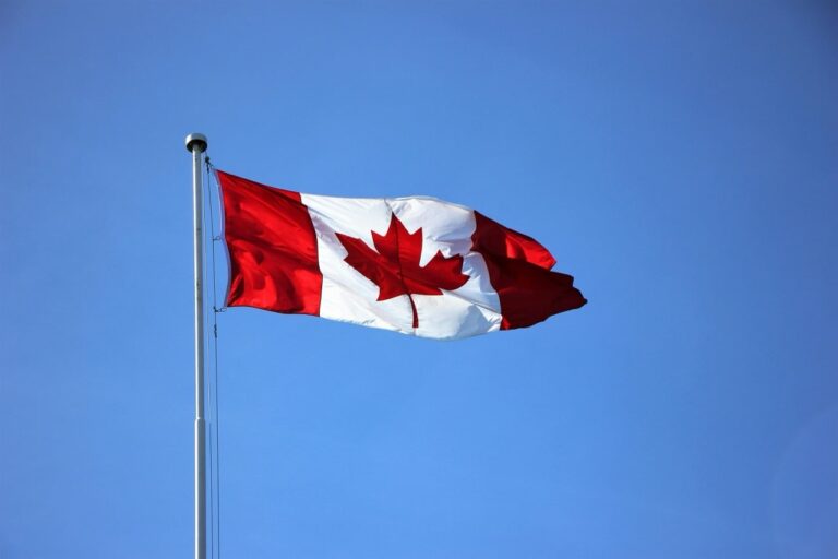 canadian flag flying in the wind