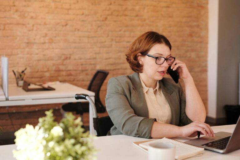 Woman speaking on her cellphone in an office environment