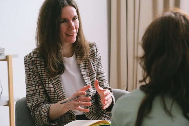 Two woman talking in a formal setting
