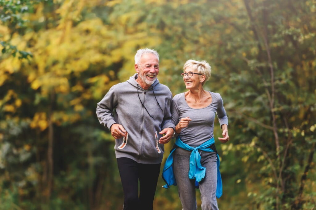 Husband and wife running outdoors